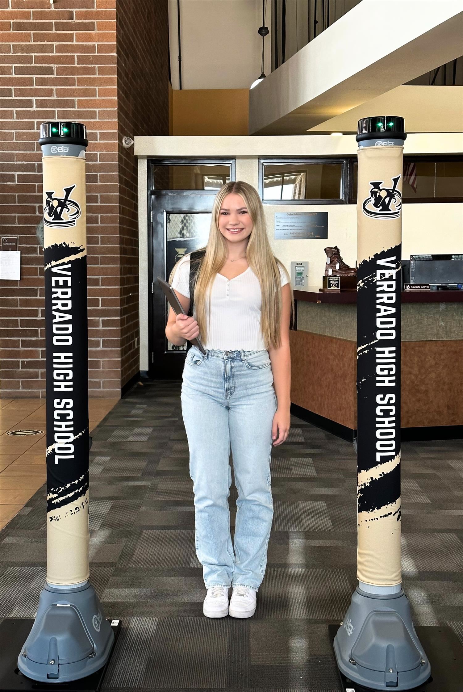 Teen girl smiling by the metal detectors Teen girl smiling by the metal detectors